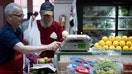 Thomas Calomiris, a third generation produce vendor, weighs an onion at Eastern Market as the US struggles with rising inflation May 20, 2022, in Washington, DC. (Photo by Brendan Smialowski / AFP) (Photo by BRENDAN SMIALOWSKI/AFP via Getty Images)