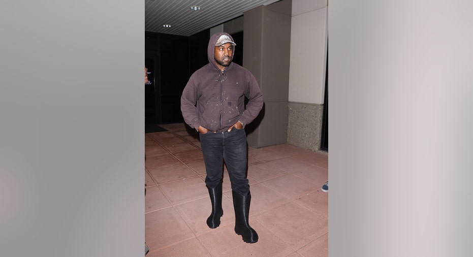 Kayne West in black rain boots