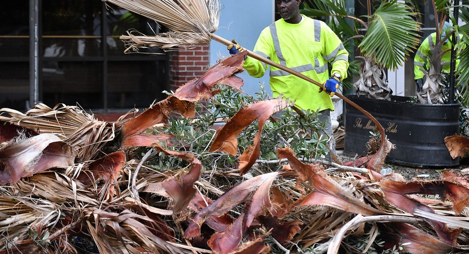 Worker cleaning Hurricane Ian debris