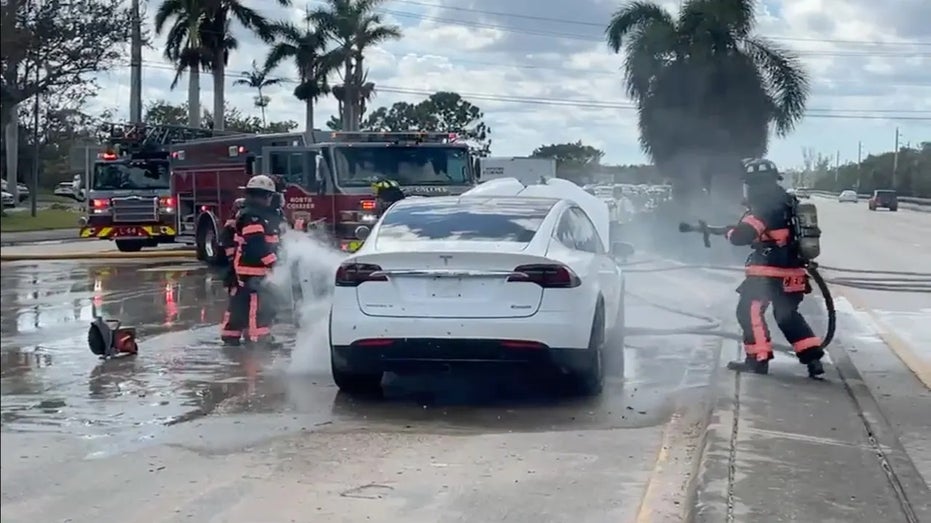 Firefighters battle Tesla fire
