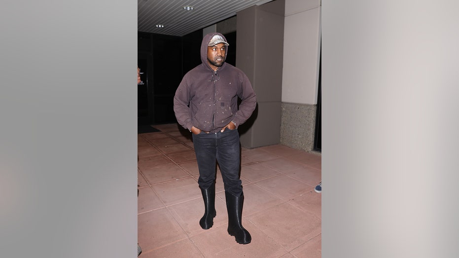 Kayne West in black rain boots