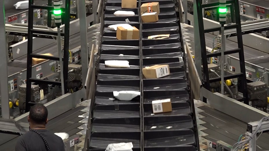 packages on a conveyor belt at UPS facility