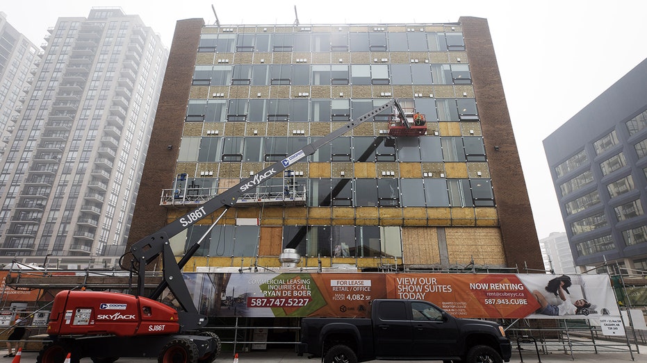 Contractors work on apartment building 