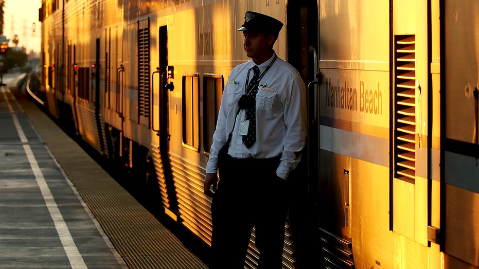 Train conductor waits on platform