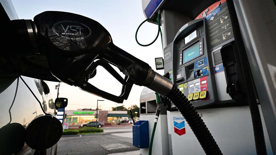 A gas pump with a car fueling up