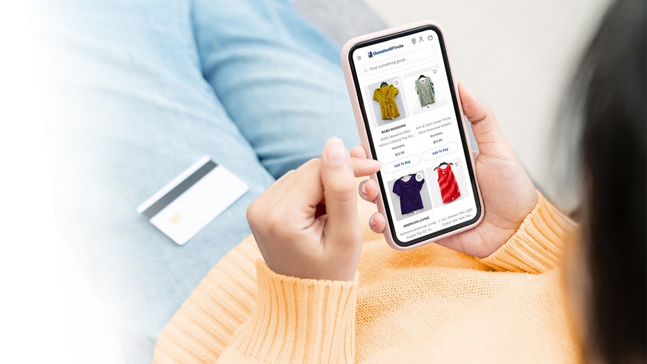 GoodwillFinds website shown on phone