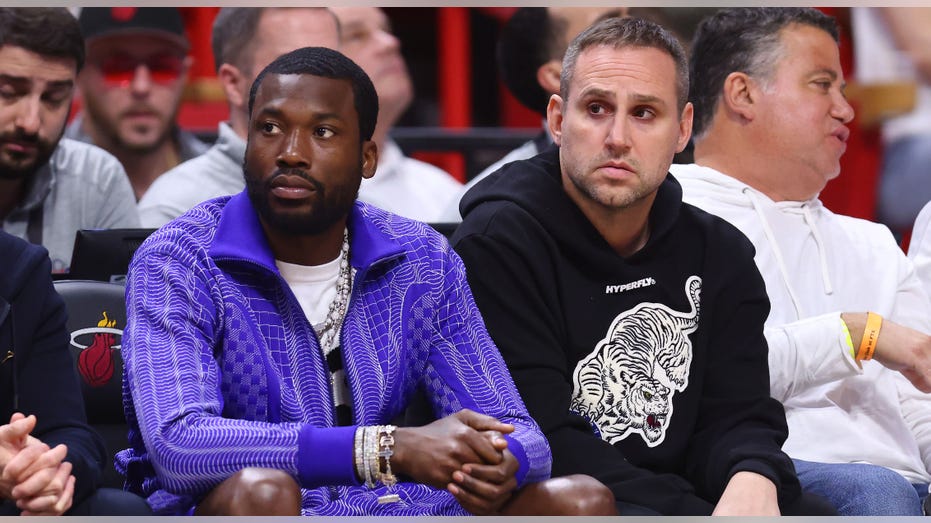 Meek Mill and Michael Rubin watching game