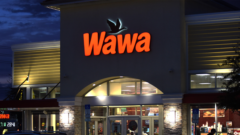 Photo of exterior Wawa at night with sign lit up 