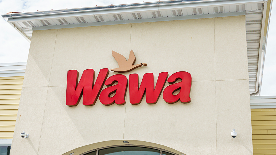 Exterior Wawa shot during the day with sign against pale building