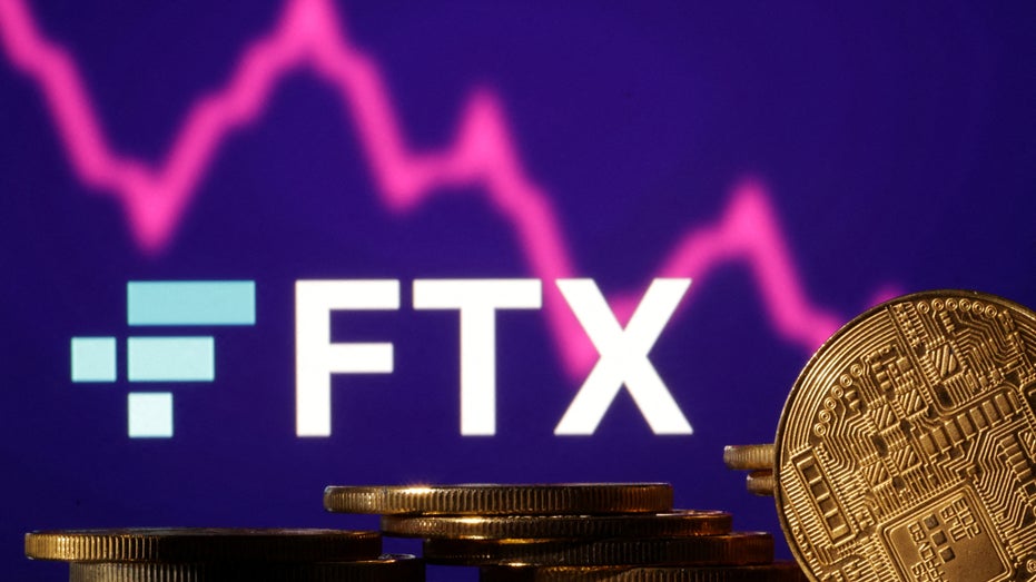 The FTX logo over Representations of cryptocurrencies and a decreasing stock market graph