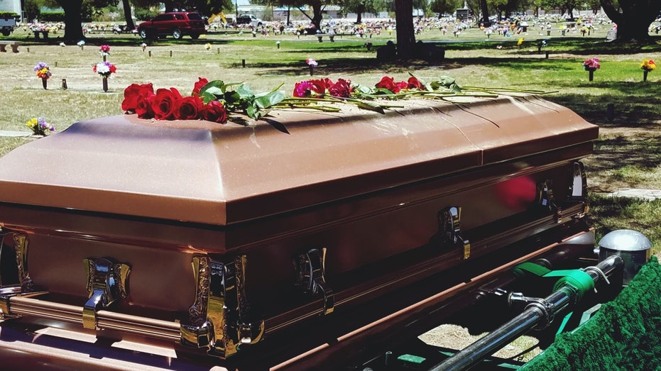 Decorated casket in cemetery