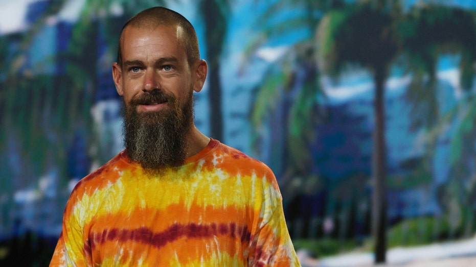 Jack Dorsey with beard and orange shirt