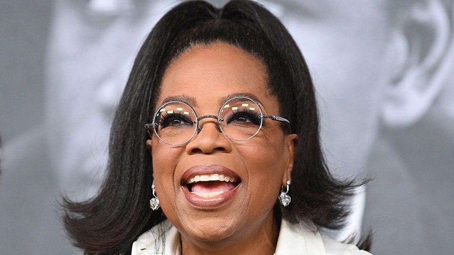 Oprah smiles at the Academy Museum of Motion Pictures carpet