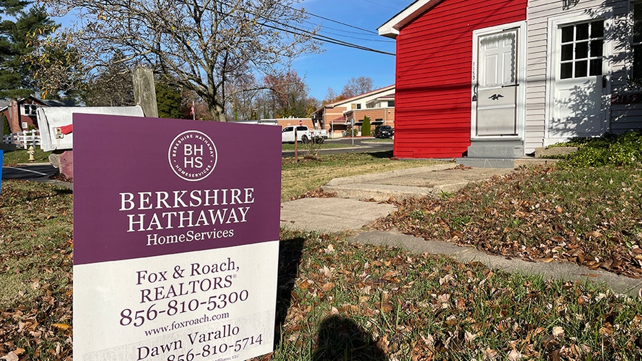 For sale sign in front of house