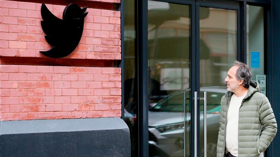 A man stands outside Twitter headquarters in New York City