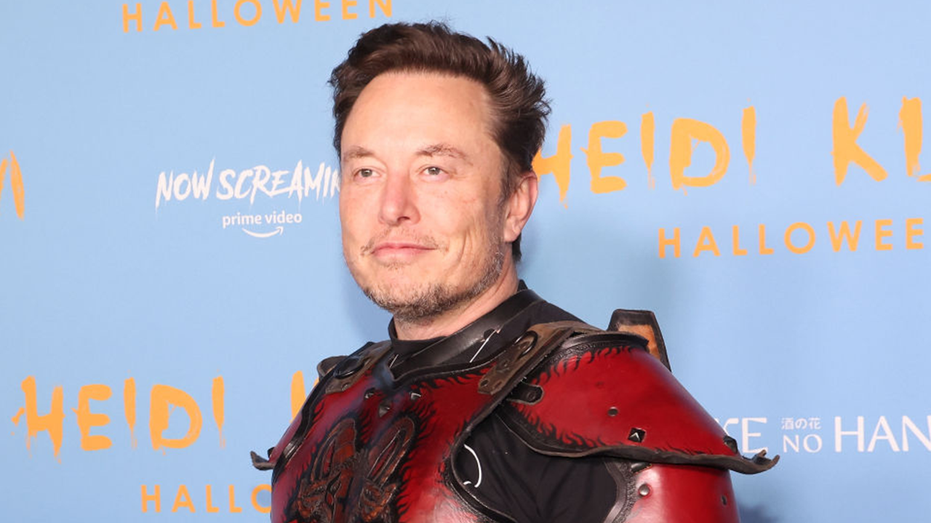 Elon Musk smiling in his Halloween costume in NYC