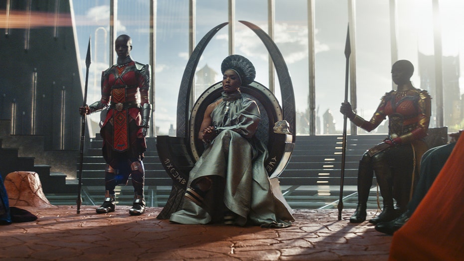 Queen Ramonda played by Angela Bassett sits on her throne