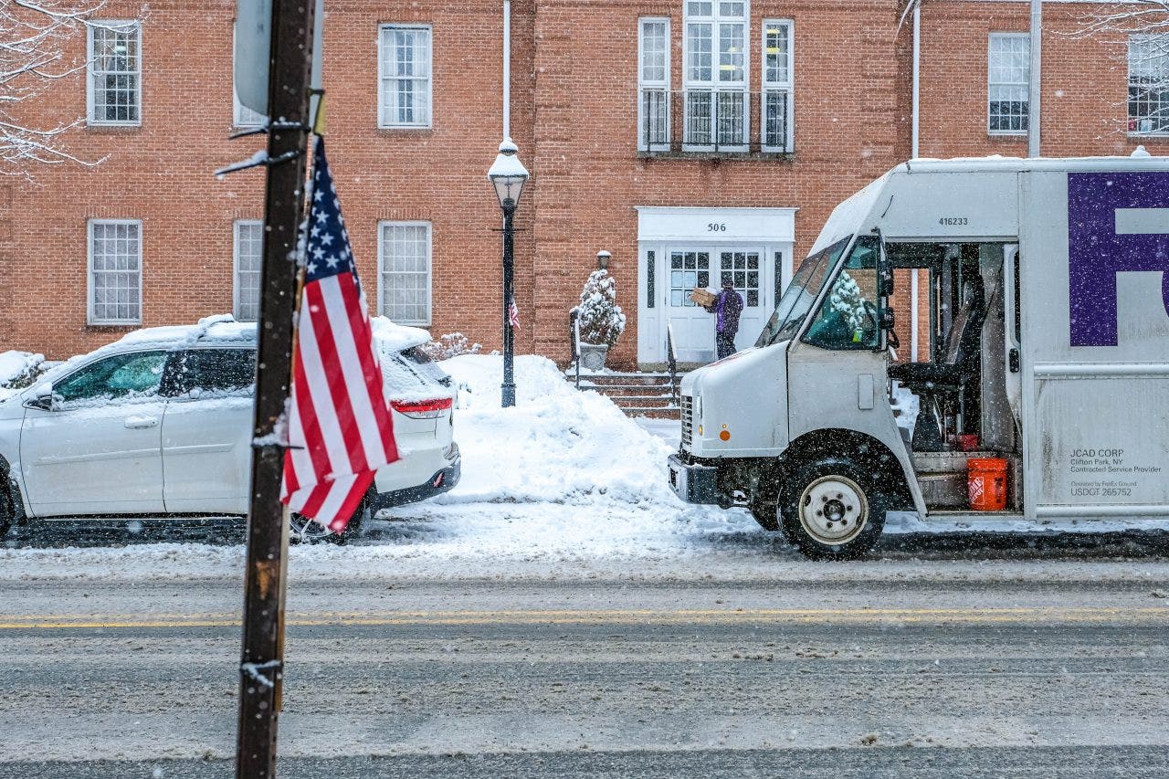 FedEx and UPS are warning of possible delivery delays as a winter storm sweeps across the country