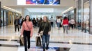 People carrying shopping bags walk inside the King of Prussia shopping mall, as shoppers show up early for the Black Friday sales, in King of Prussia, Pa., U.S. Nov. 26, 2021.  