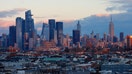 FILE: The sun sets on the skyline of midtown Manhattan, the Empire State Building and Hudson Yards in New York City on December 17, 2022, as seen from Jersey City, New Jersey. 