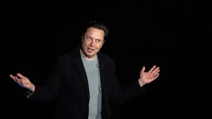 Elon Musk gestures as he speaks during a press conference at SpaceX's Starbase facility near Boca Chica Village in South Texas on February 10, 2022. 
