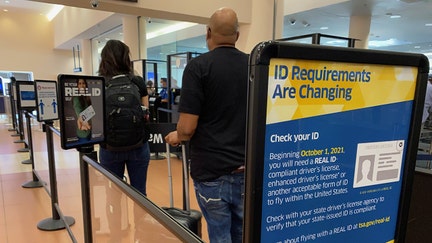 ID requirement signs at entrance to passenger TSA security area, West Palm Beach, Florida