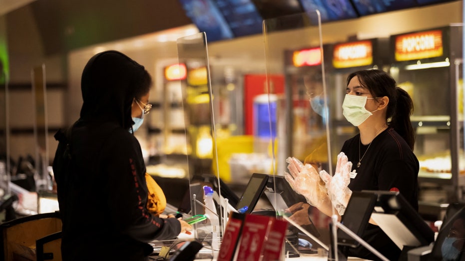 Moviegoer shops at concessions stands at a AMC theatre on reopening day during the outbreak of the coronavirus disease (COVID-19), in Burbank