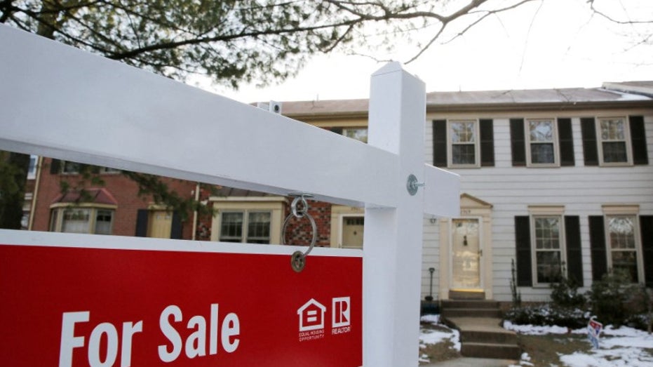 For sale sign in front of home in show