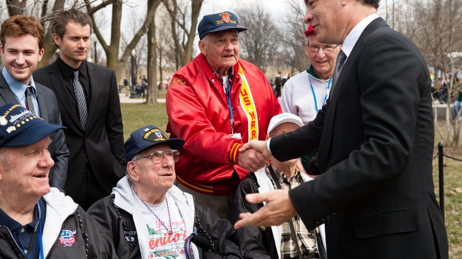 Tom Hanks speaks with WWII veterans.