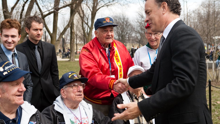 Tom Hanks speaks with WWII veterans.