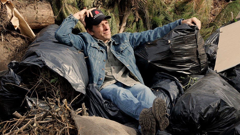 Mike Rowe surrounded by garbage
