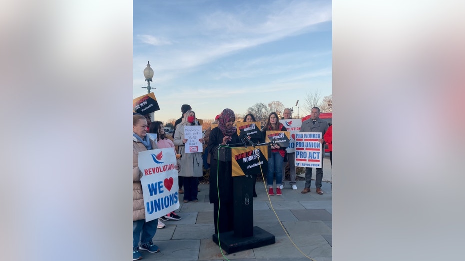 Ilhan Omar speaks at lectern outside Capitol