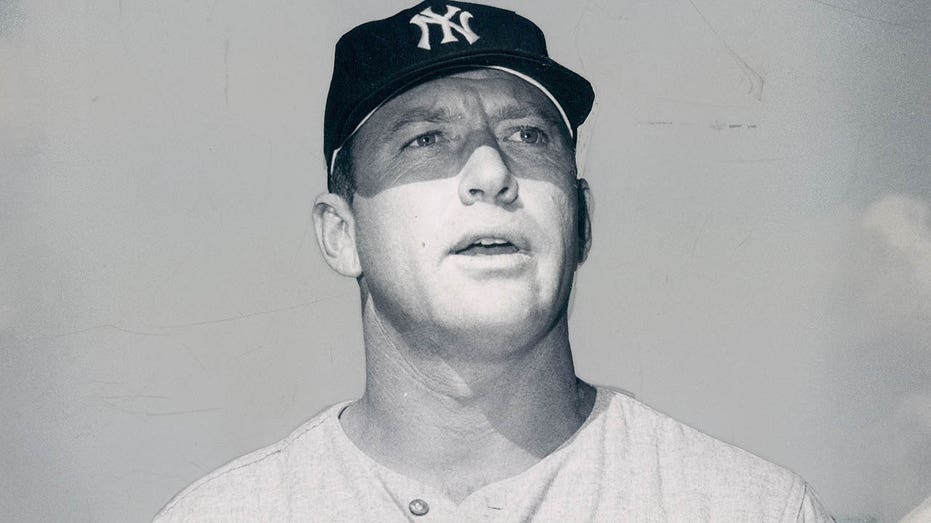 Mickey Mantle poses with a bat