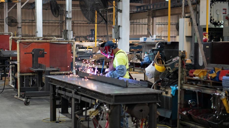 Julio Ventura welds a screed bottom for a commercial class road paver at the Calder Brothers factory in Taylors, South Carolina, U.S., in this handout picture taken July 18, 2021. Brandon Granger/Calder Brothers Corporation/Handout via REUTERS