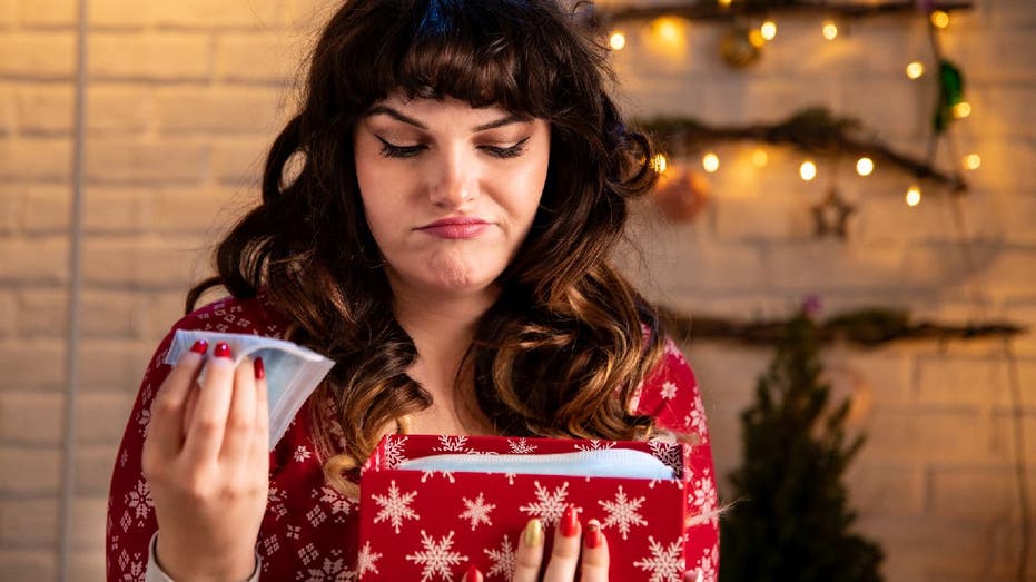Woman frowns at disappointing holiday gift