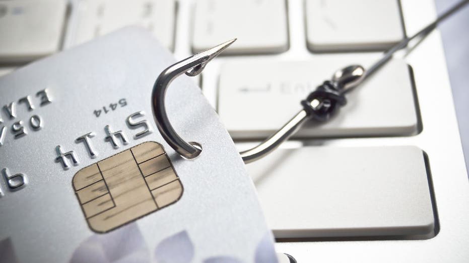 Phishing scam illustration with a fish hook piercing a credit card