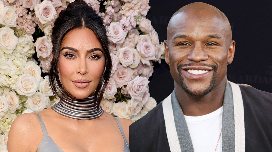 Kim Kardashian smiles alongside boxing legend Floyd Mayweather Jr.