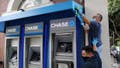 A man cleans the side of a Chase Bank ATM in Santa Monica, California, U.S., June 1, 2020. REUTERS/Lucy Nicholson/File Photo