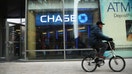 NEW YORK, NY - FEBRUARY 24:  A man rides a bike past a Chase bank branch in Manhattan on February 24, 2015 in New York City. JPMorgan Chase announced today that they plan to close 300 bank branches over the next two years. The cuts come as customers continue to move online 