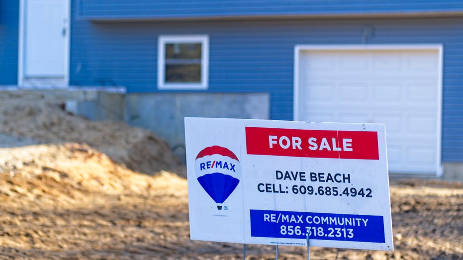 New home for sale with sale sign outside