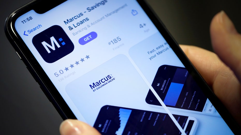 Woman looks at Marcus, a new savings and loans app recently launched by Goldman Sachs in New York