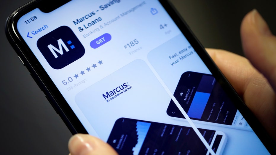 Woman looks at Marcus, a new savings and loans app recently launched by Goldman Sachs in New York