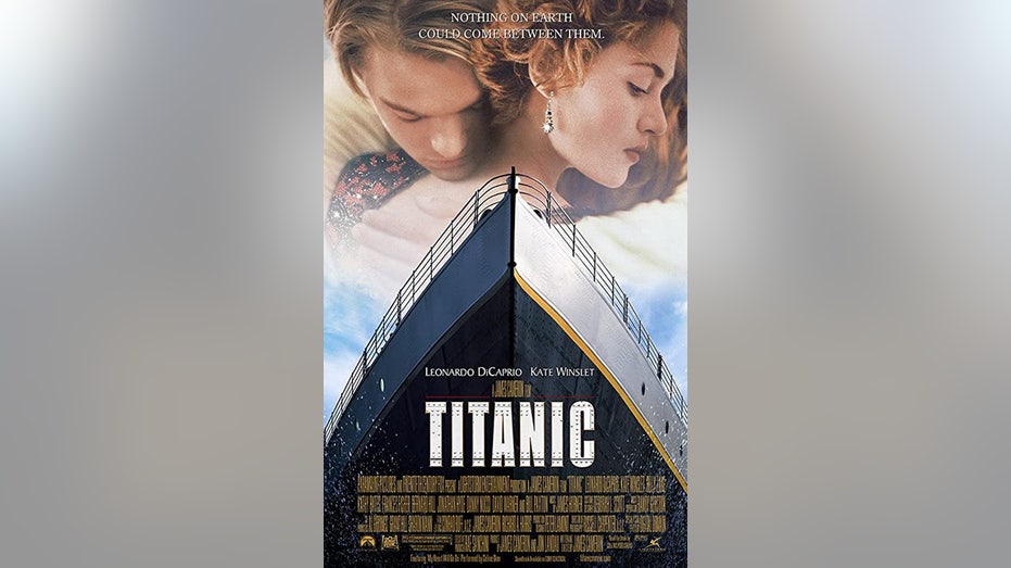 Titanic poster featuring Leonardo DiCaprio holding on to Kate Winslet and a large ship in the forefront