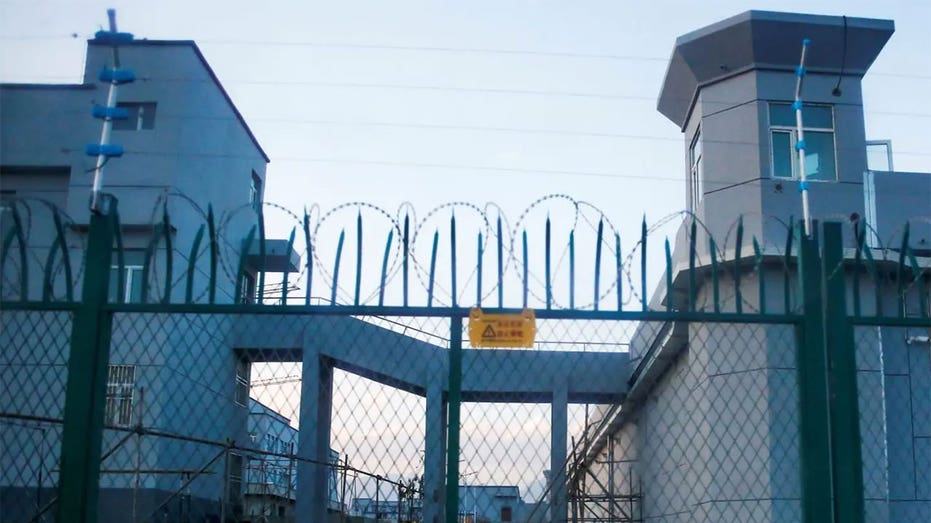 A heavily guarded vocational skills education center with a spiked fence and barbed wire.