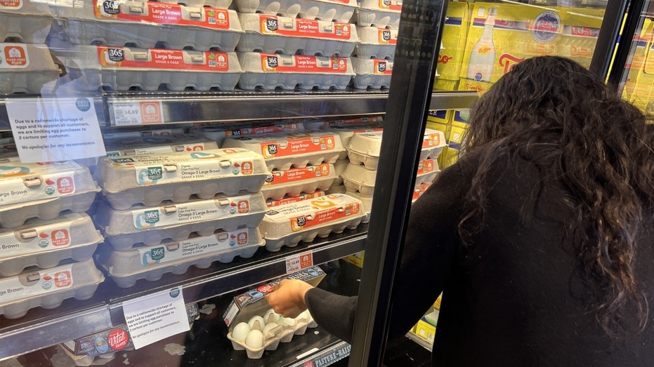 A woman shops for eggs