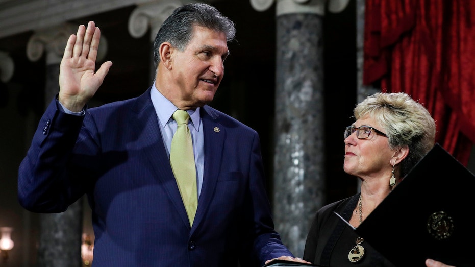 Sen. Joe Manchin is pictured next to his wife Gayle Manchin while he is sworn in on Jan. 3, 2019.