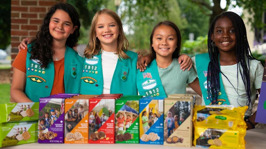 Girl Scouts stand at sales booth