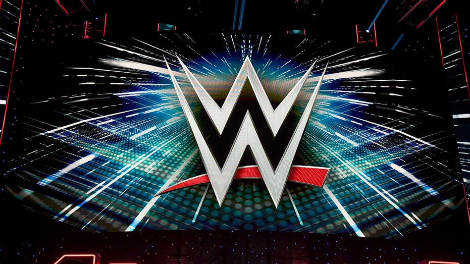 A WWE logo is shown on a screen