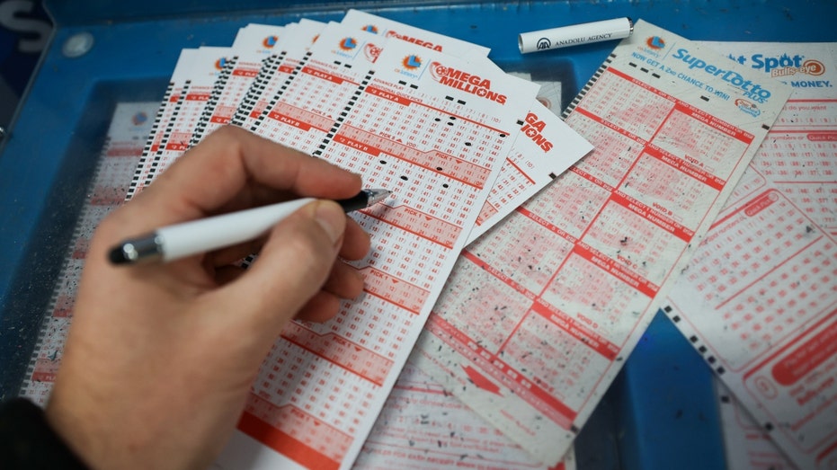 A man fills out lottery tickets