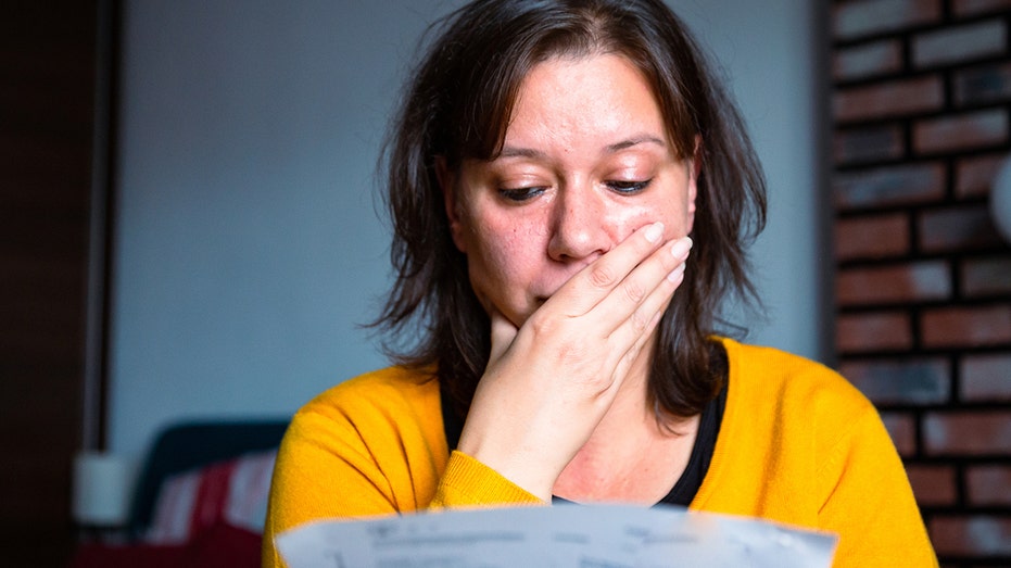 woman stressed looking at bill